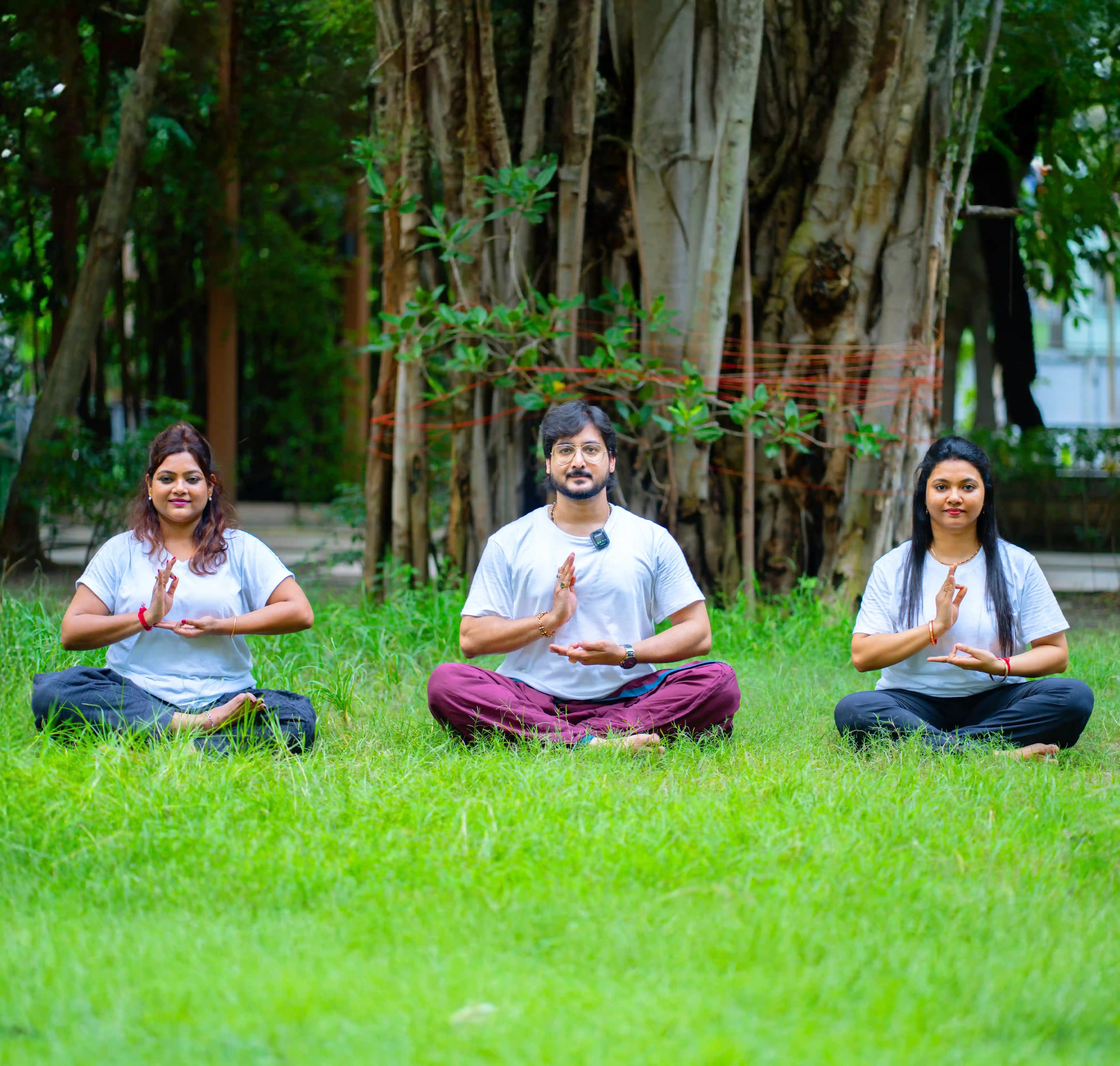 A student finding inner peace and focusing on the kundalini chakra during quiet yoga classes at home, thoughtfully guided by Gaurav Tribedi at Nabatara, set against a calming golden and maroon background.